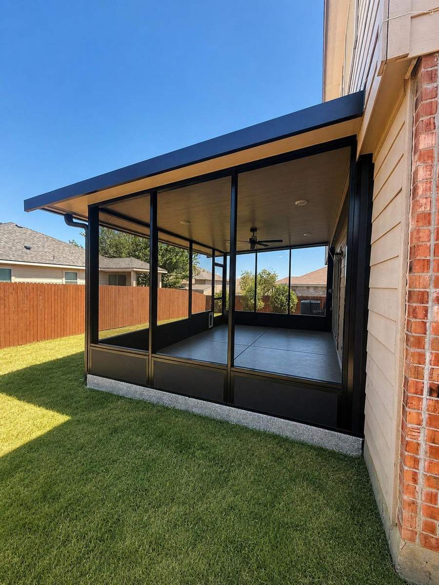 Almanza screen room exterior, dark bronze frames against brick