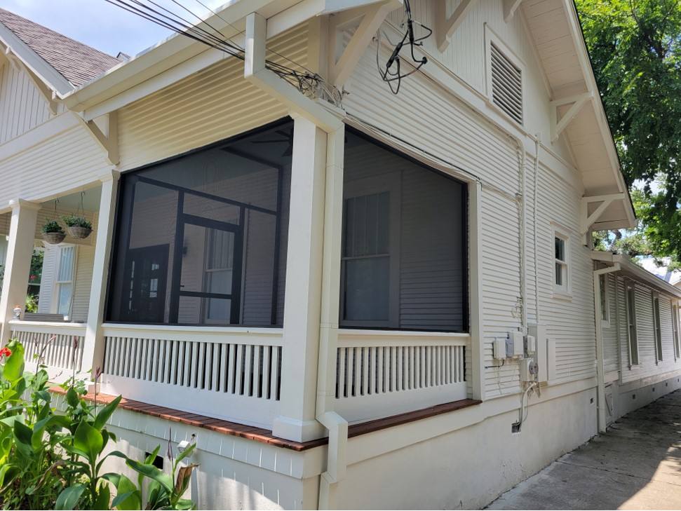 Screened porch on a classic craftsman with spindle railing
