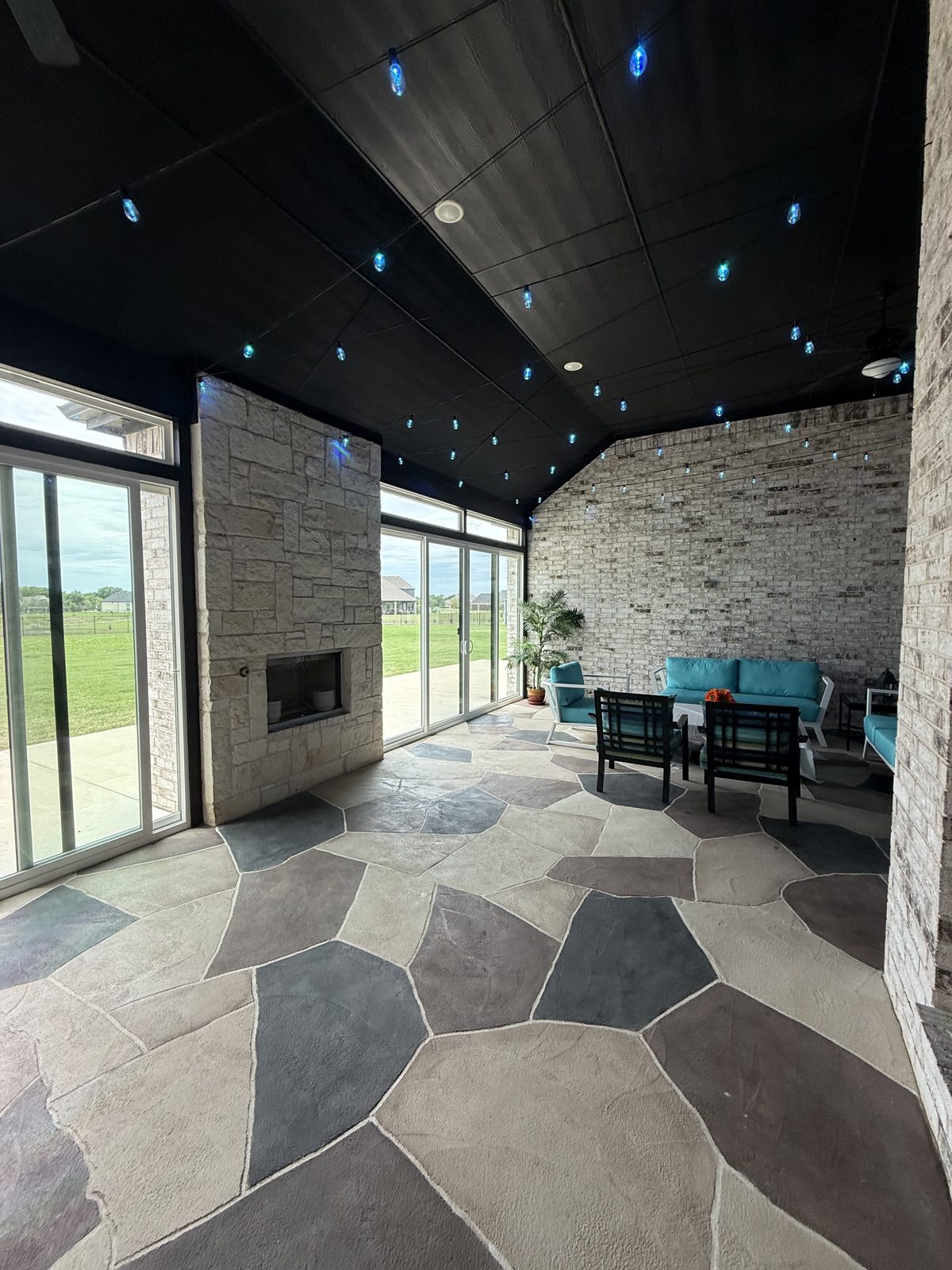 Enclosure interior with stone fireplace and dark ceiling