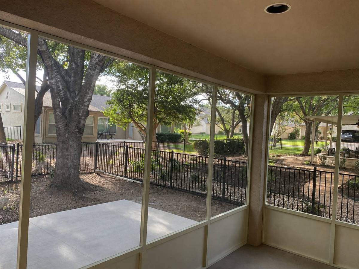 Inside the Jacobs screened porch looking out to the oaks