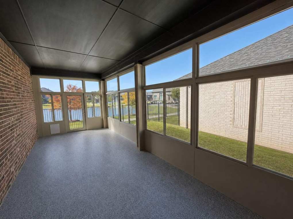 Inside the Lakeside sunroom — coated floor, glass walls, lake beyond