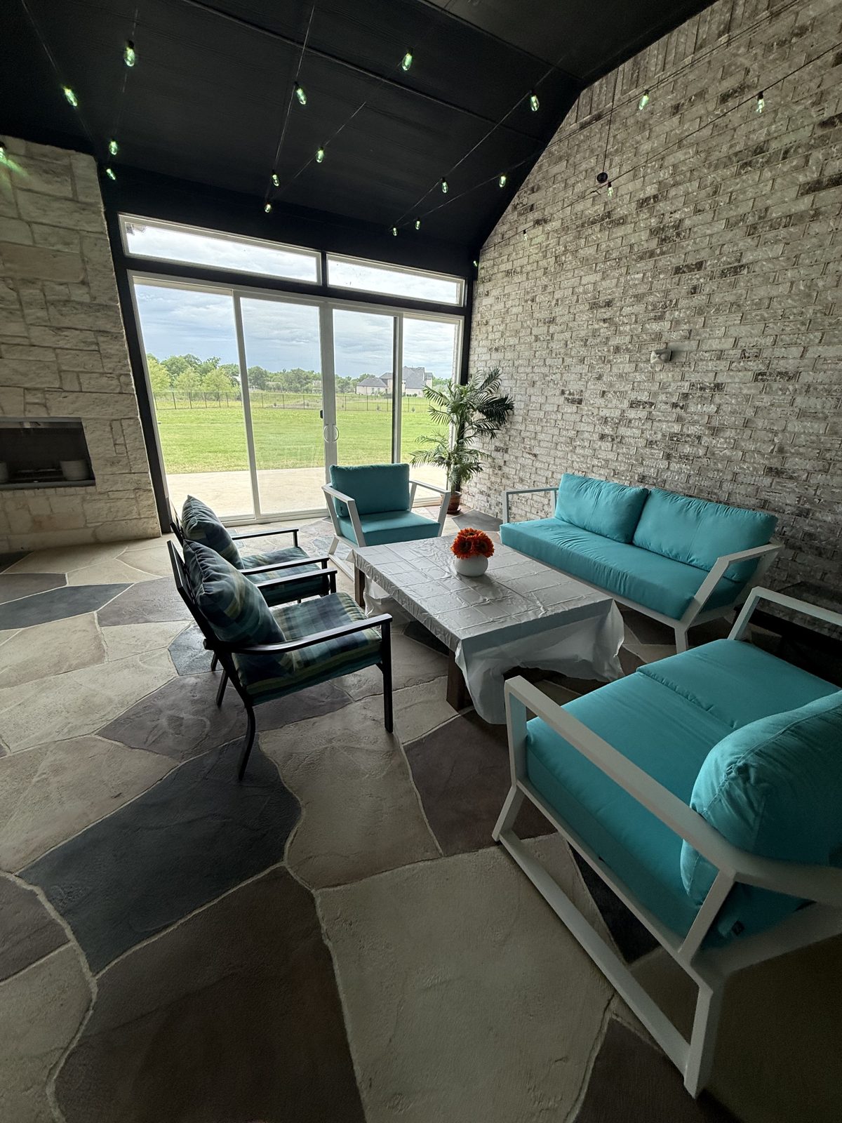Enclosed patio lounge with stone fireplace