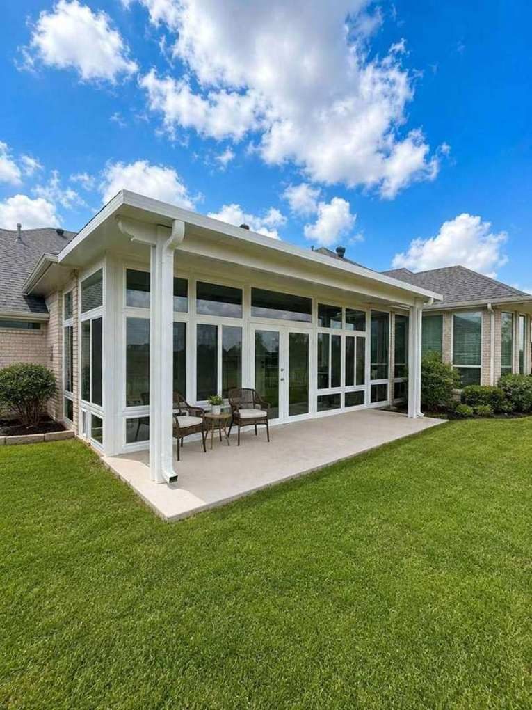 The Parker — white glass sunroom under a blue Texas sky