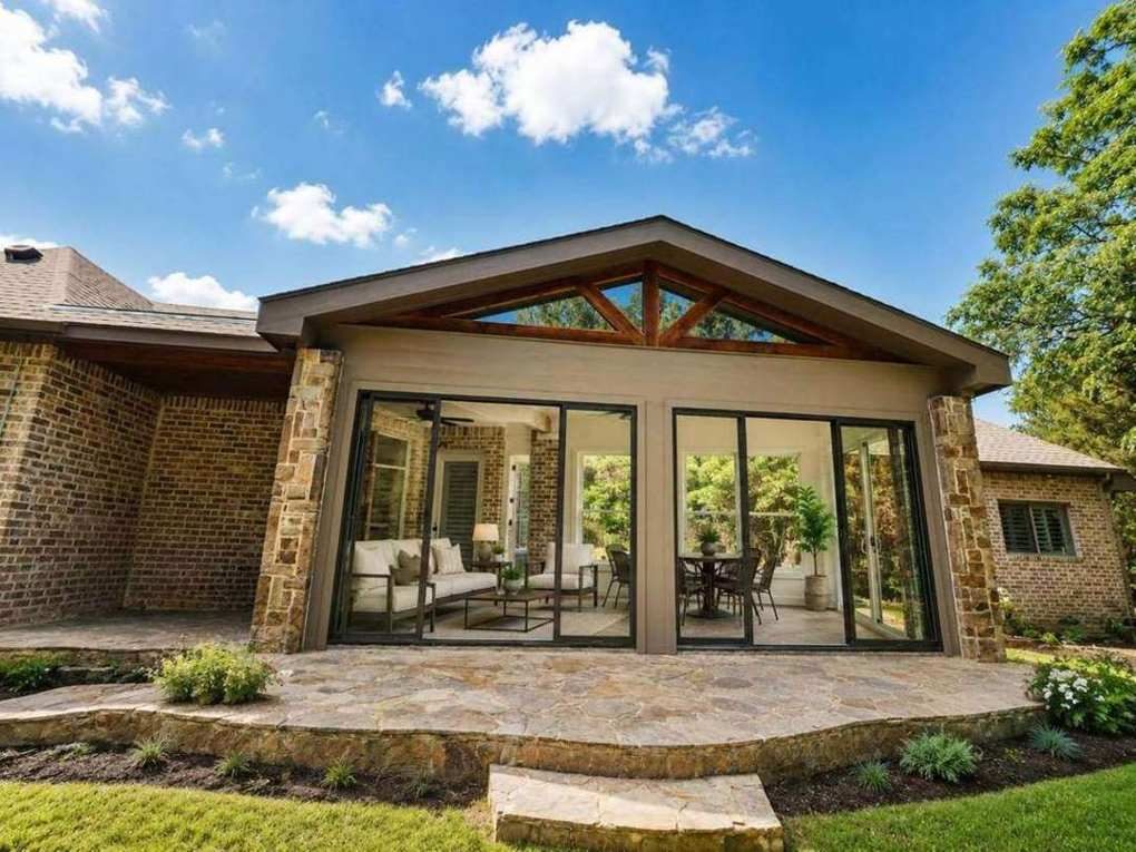 The Rockwall — stone and glass gabled patio enclosure