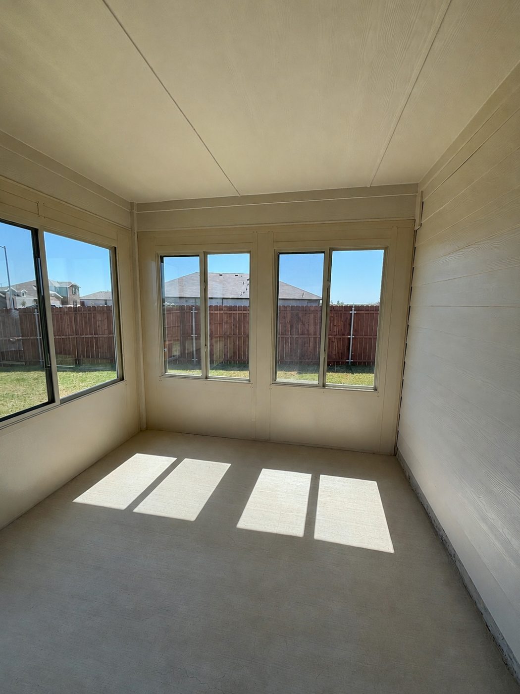 Inside the Sidel sunroom — sliders and windows on two walls