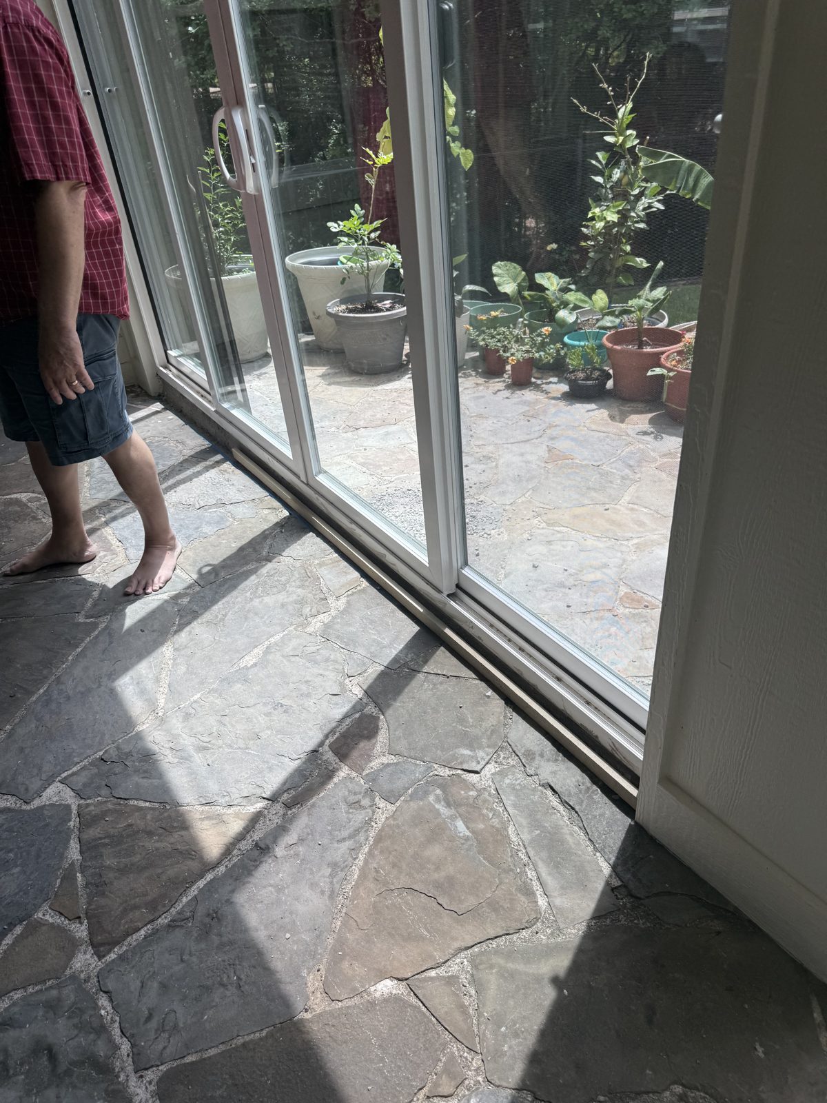 Sliding glass doors over flagstone floor