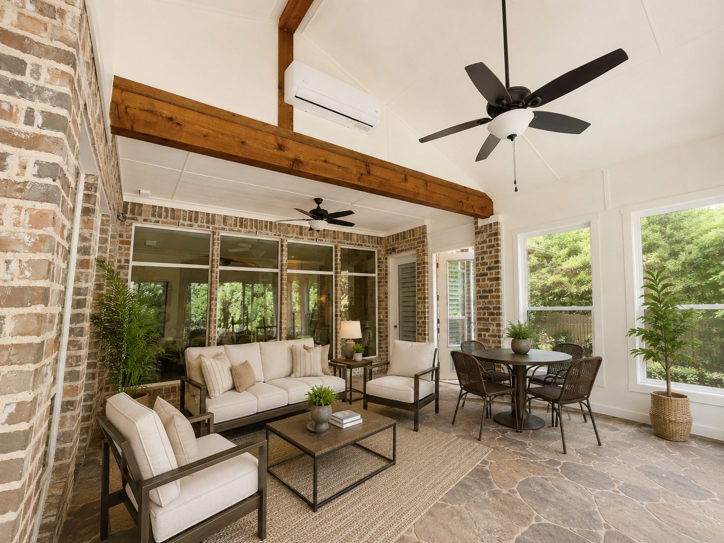 Enclosed patio with stone fireplace and dark ceiling