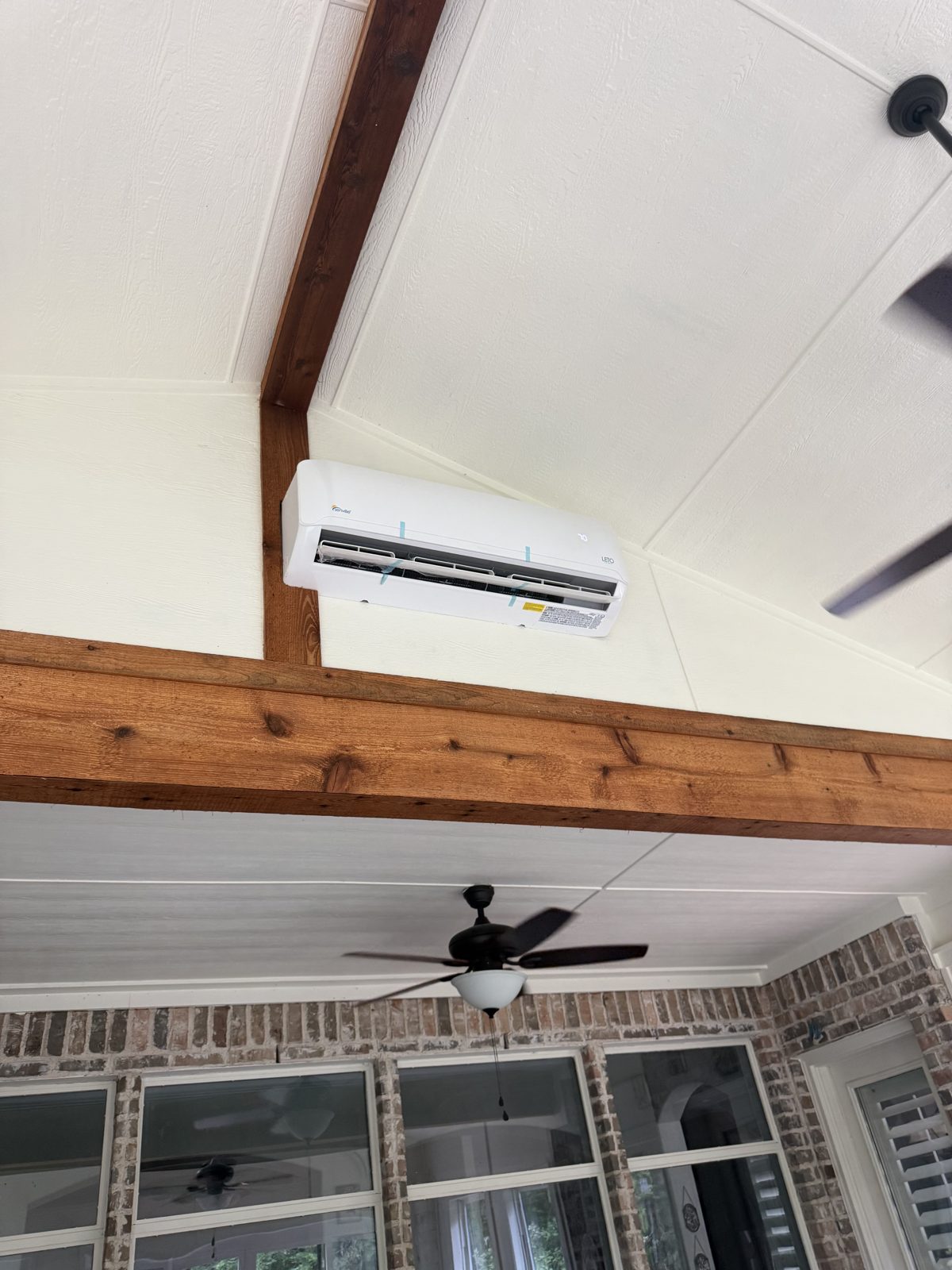 Vaulted enclosure ceiling with cedar beam and fan